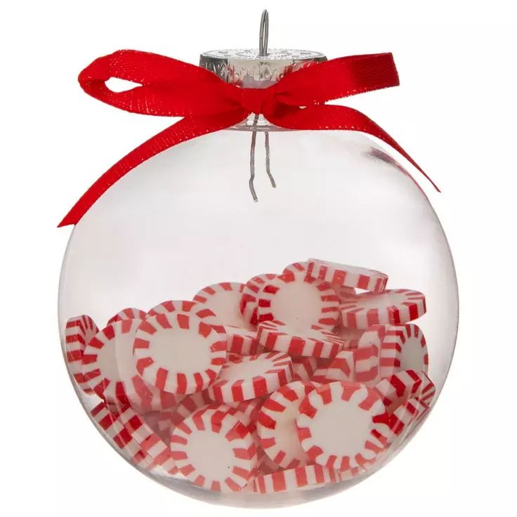 a glass ornament filled with candy canes