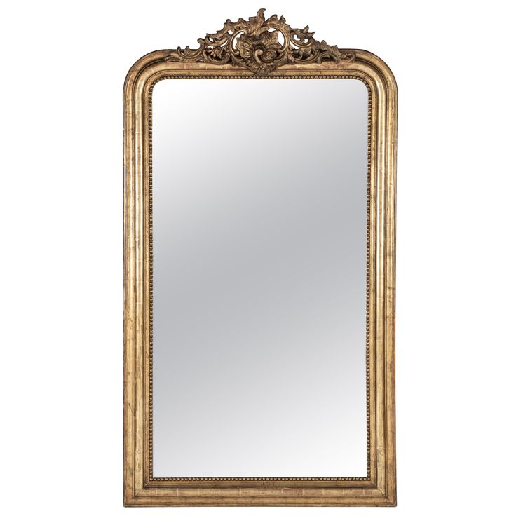 an ornate gold framed mirror against a white background