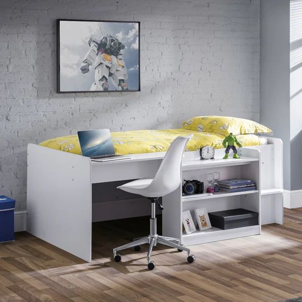 a white bed with a desk underneath it