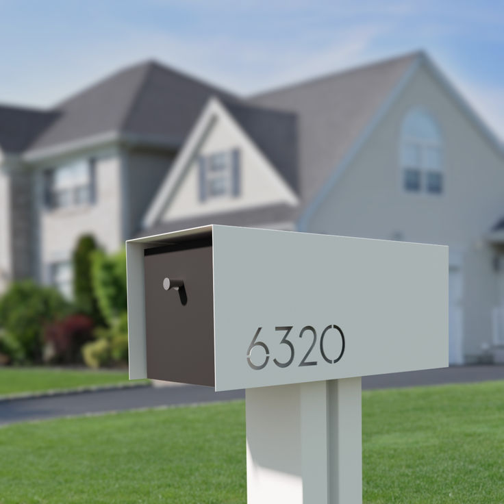 a mailbox in front of a house with the number 5320 written on it