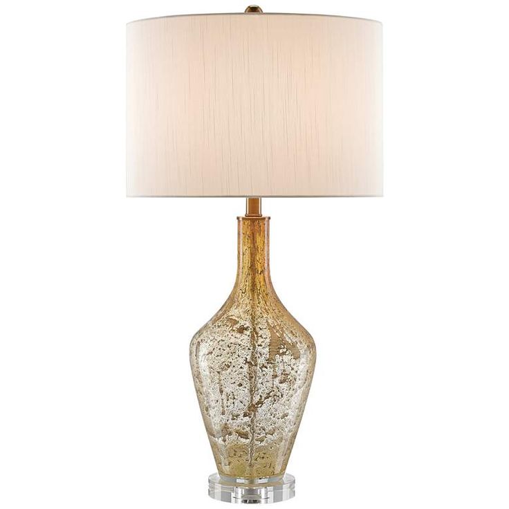 a glass table lamp with a white shade