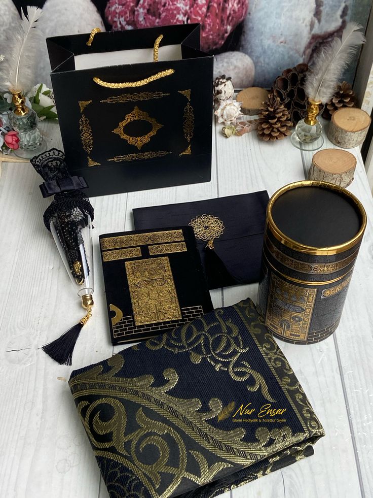 the table is covered with black and gold paper, decorative items, and other decorations