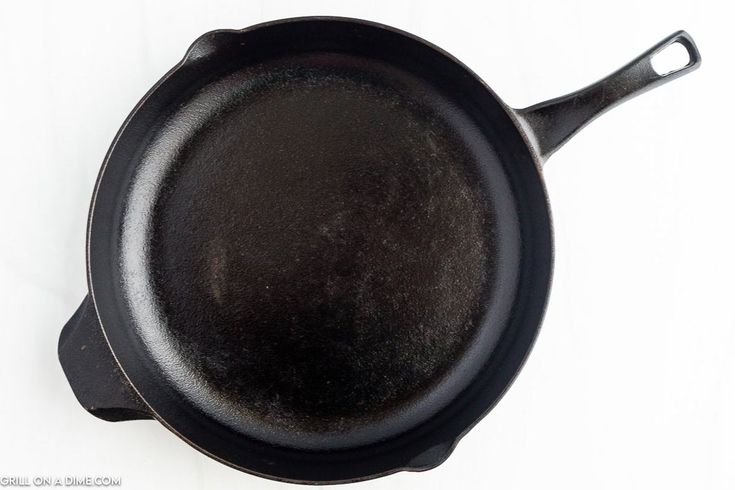 an empty cast iron skillet on a white background