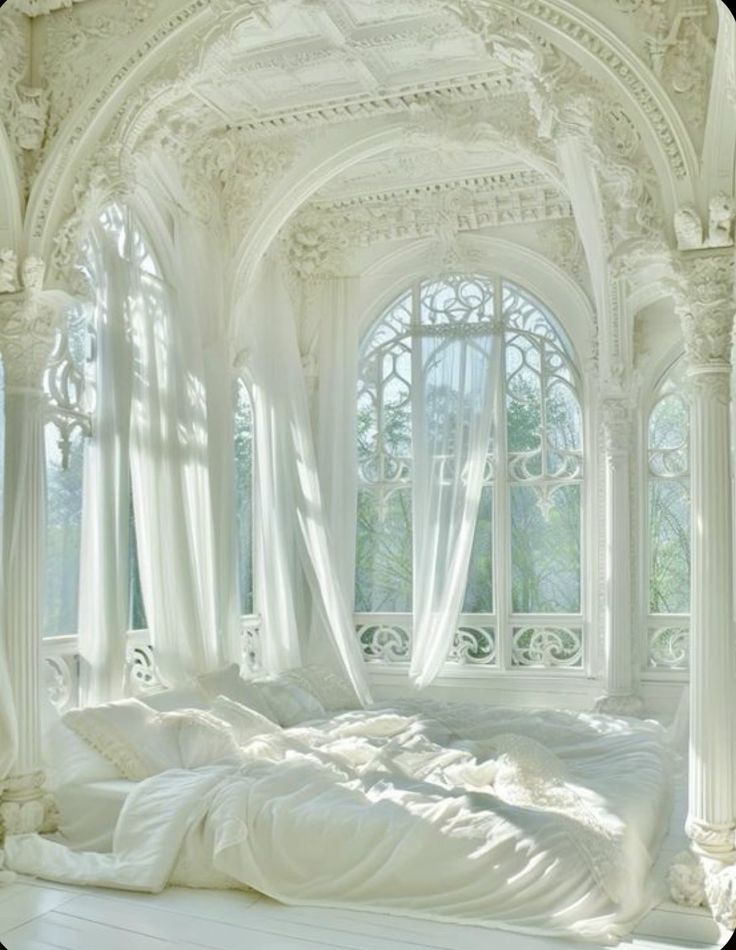 a white bed sitting under a window in a bedroom