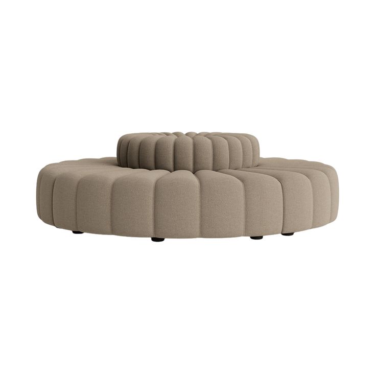 a beige couch with black legs and a circular back rest on the bottom half of it