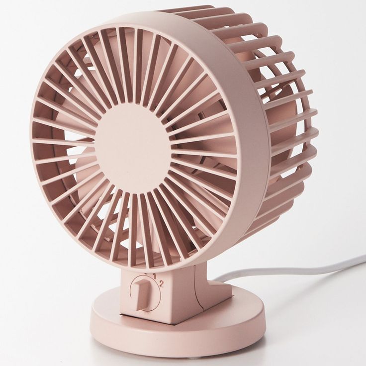 an electric fan sitting on top of a white table