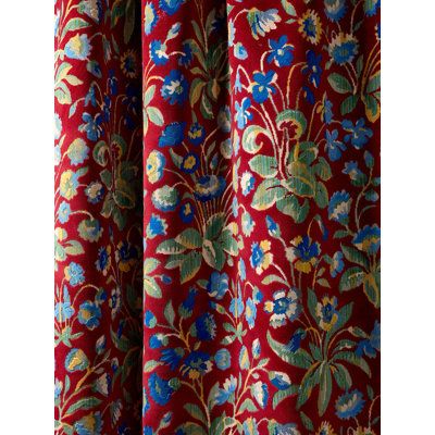 a red curtain with blue and green flowers on it