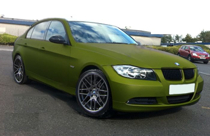 a green car parked in a parking lot