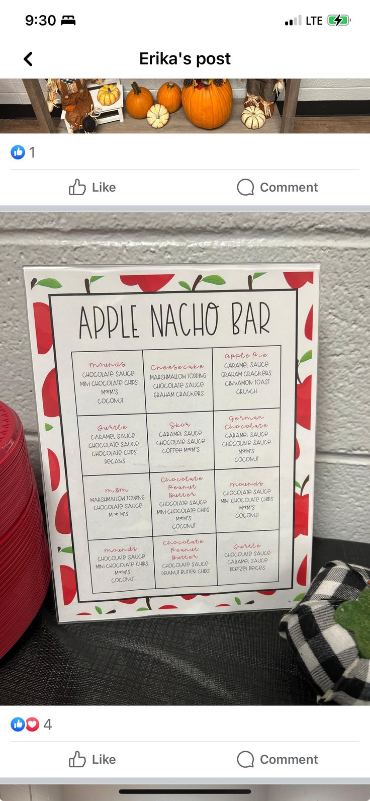 an apple nacho bar sign sitting on top of a table next to red plates