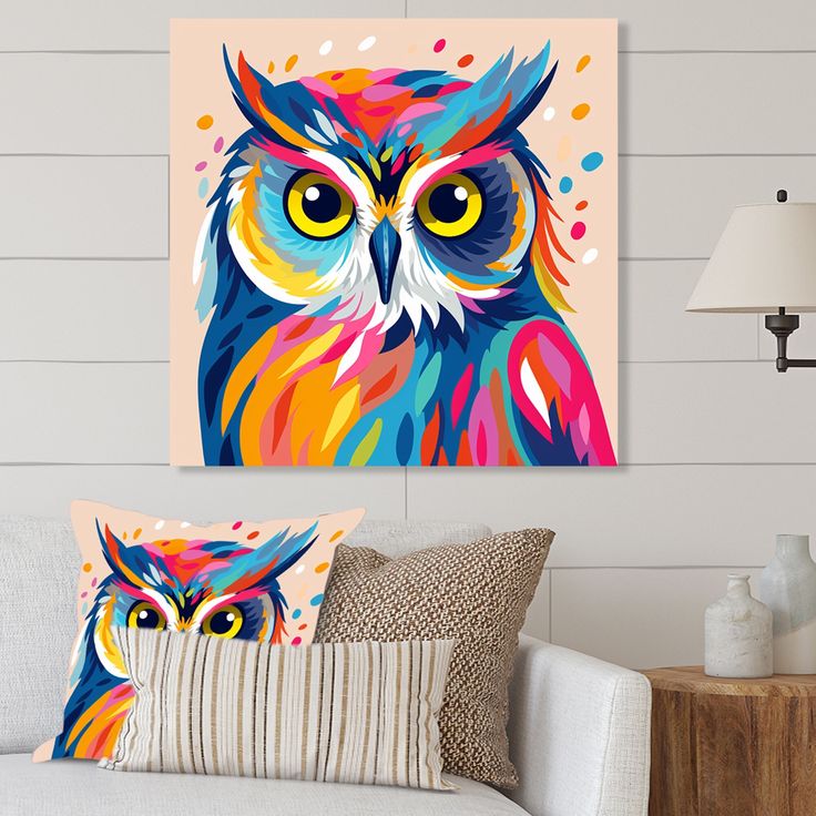 an owl painting on the wall next to a couch with two pillows and a lamp