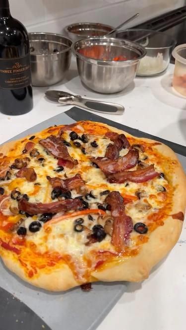 a pizza sitting on top of a pan covered in toppings