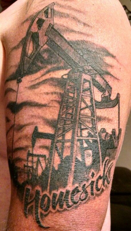 the back of a man's shoulder with an oil pump and words on it