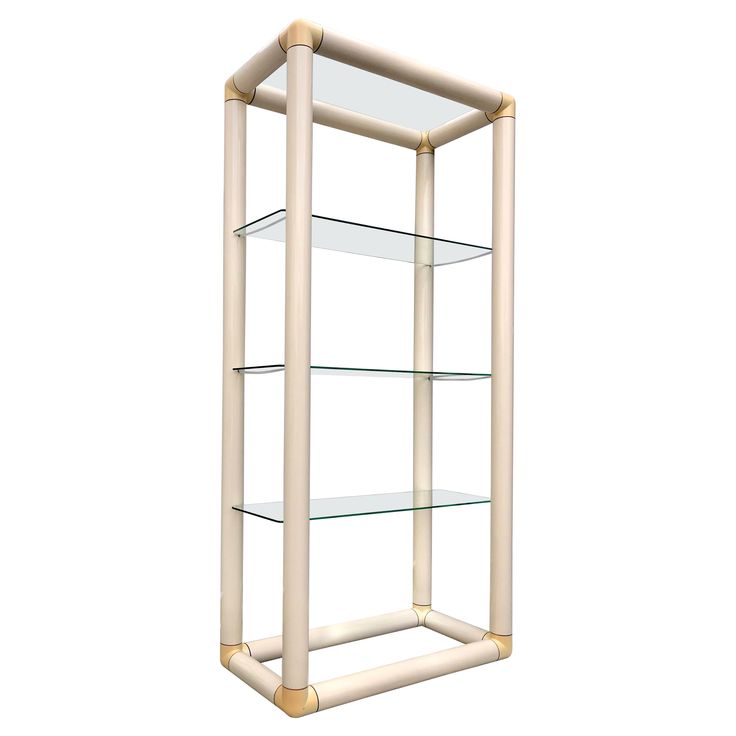 a glass shelf with three shelves on each side and gold trimmings around the bottom