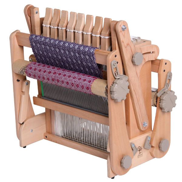 a wooden loom with two rows of yarn on it