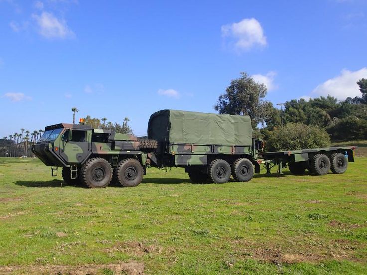 an army transport truck parked in a field