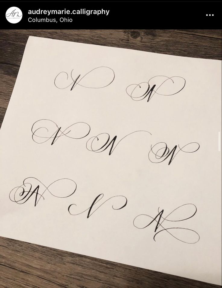 some type of calligraphy that is on top of a piece of paper