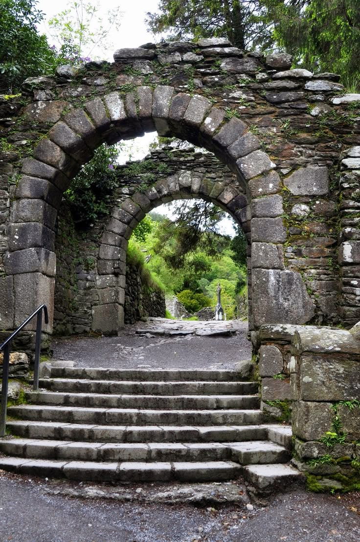 a stone arch with steps leading up to it