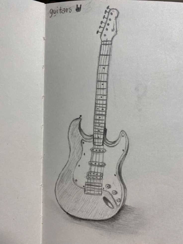 an open book with a drawing of a guitar