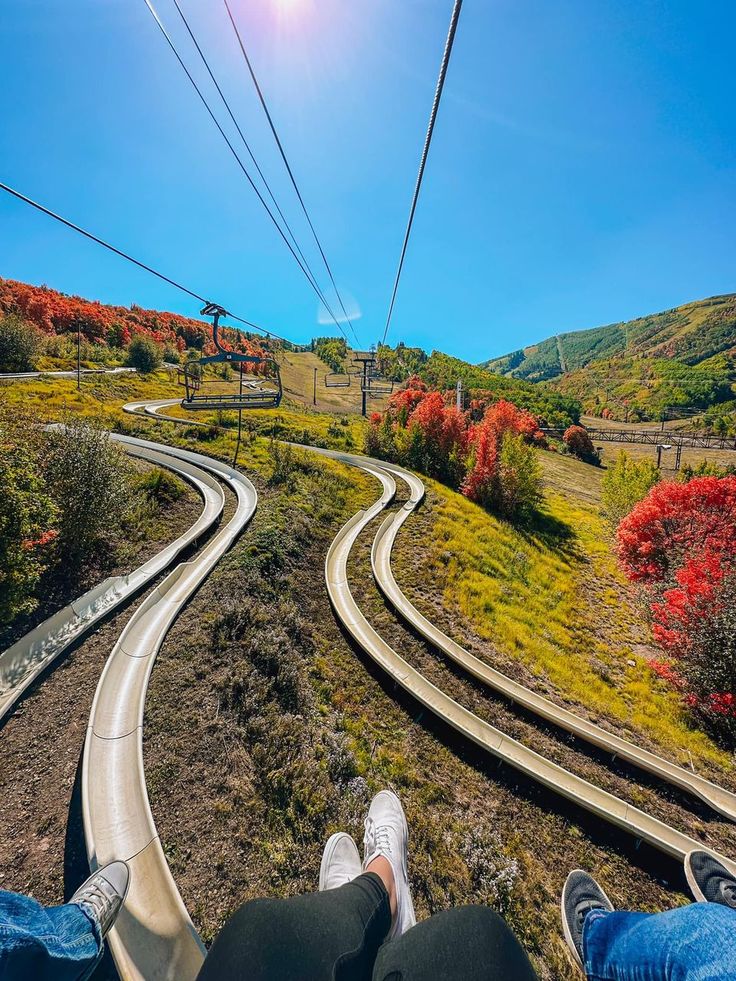 two people sitting on top of a train track