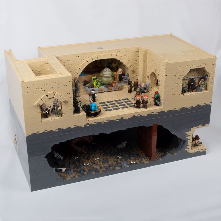 a lego model of a castle with people inside