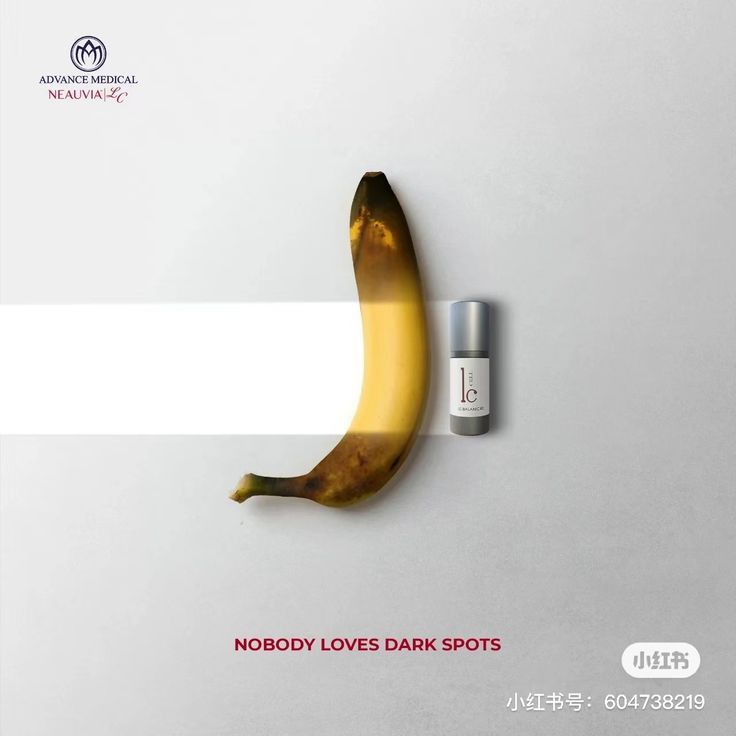 a banana with a lip balm next to it on a white background that says nobody loves dark spots