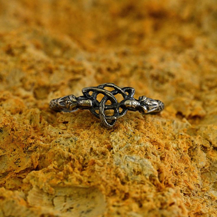 a silver ring sitting on top of a rock