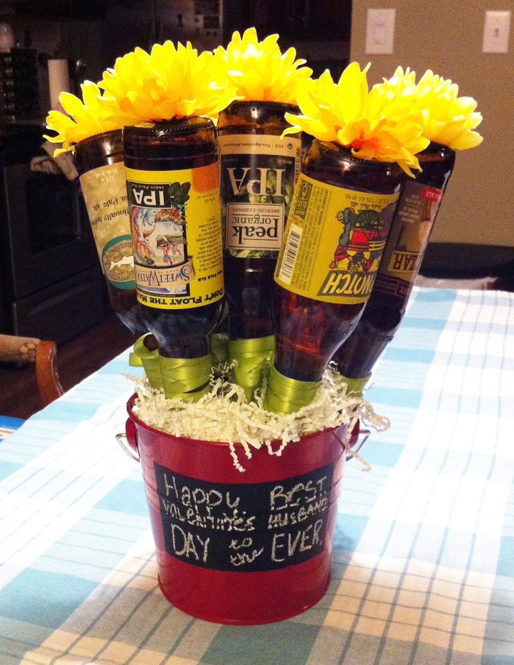 a bucket filled with beer bottles sitting on top of a table