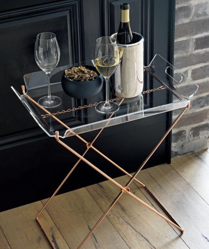 a glass and metal tray with two wine glasses on it