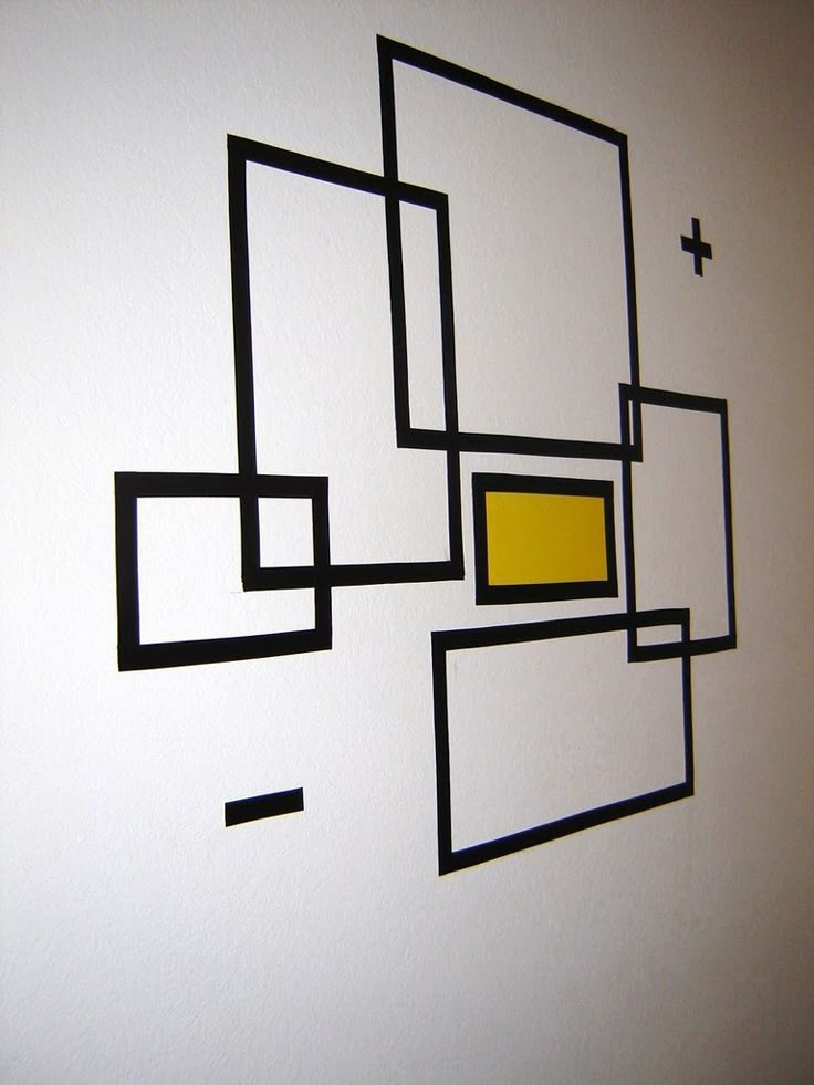 a white wall with black and yellow squares on it