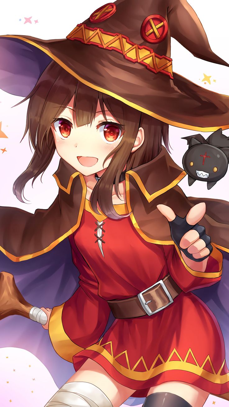 a woman in a witch costume holding a black cat and pointing at something with her right hand