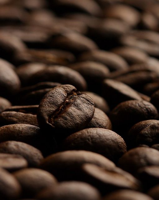 some coffee beans are laying on top of each other