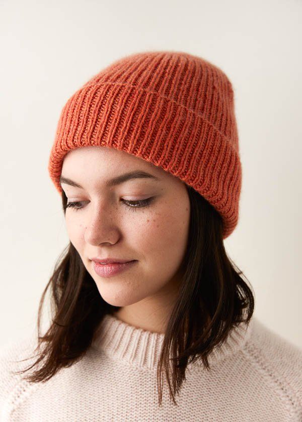 a woman wearing an orange knitted hat