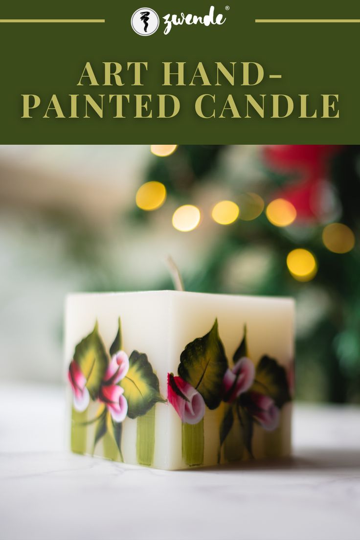 a candle that has been painted with flowers on it and the words art hand - painted candle