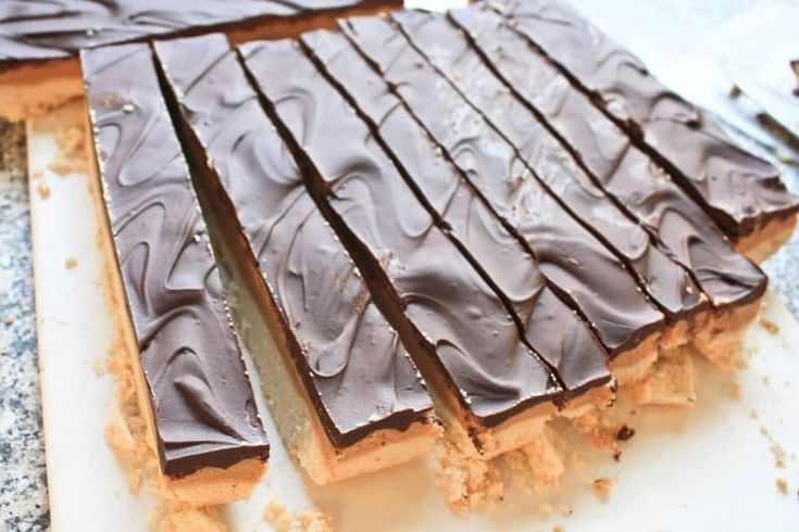 there are pieces of chocolate cake on the counter ready to be cut into squares and eat