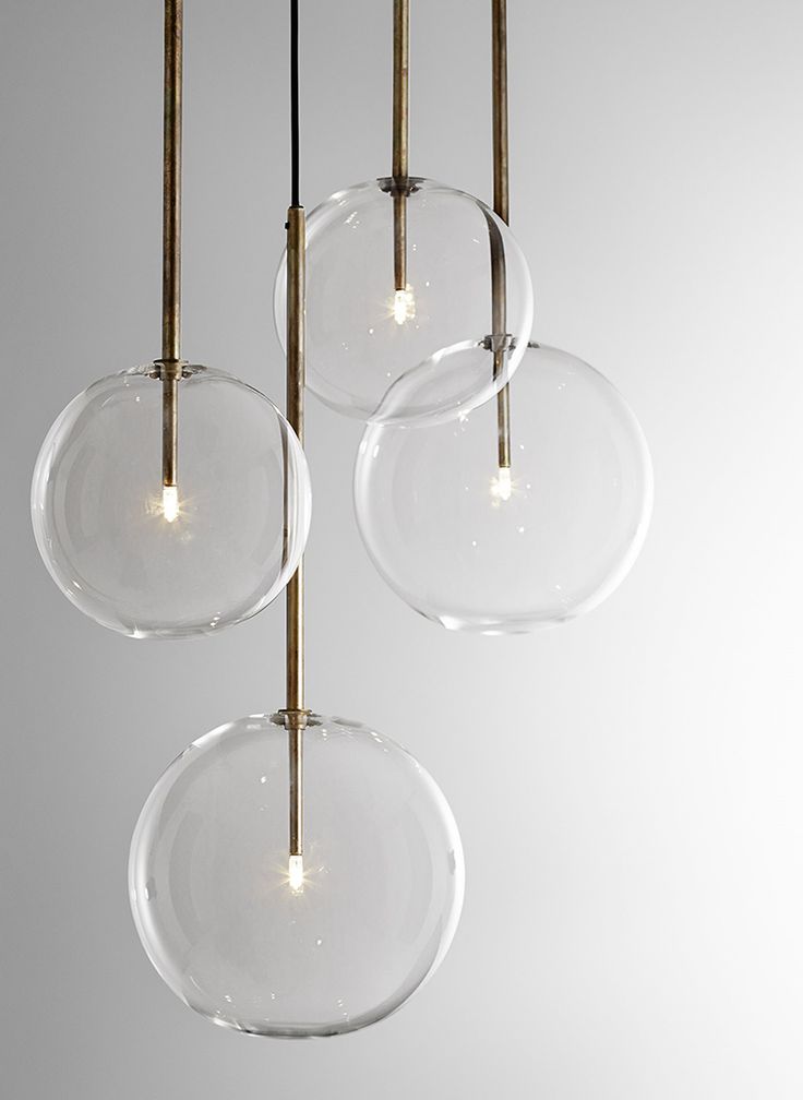 three clear glass orbs hanging from a ceiling