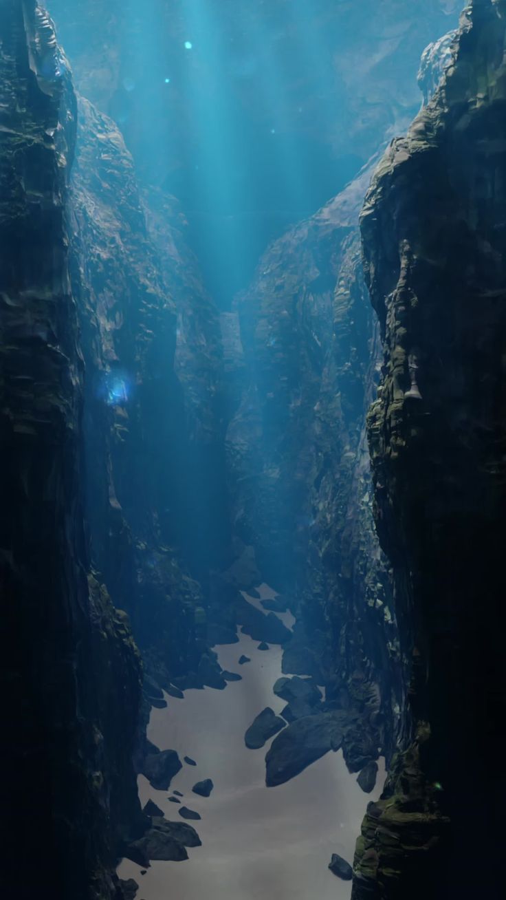 the sun shines down on an underwater canyon with rock formations and water flowing through it