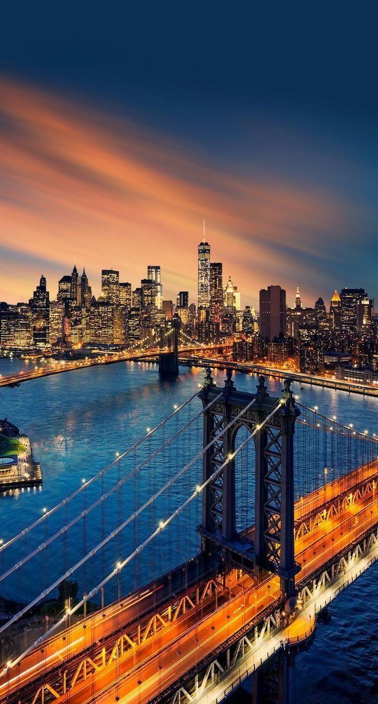 the city skyline is lit up at night as seen from across the bay bridge in san francisco, california