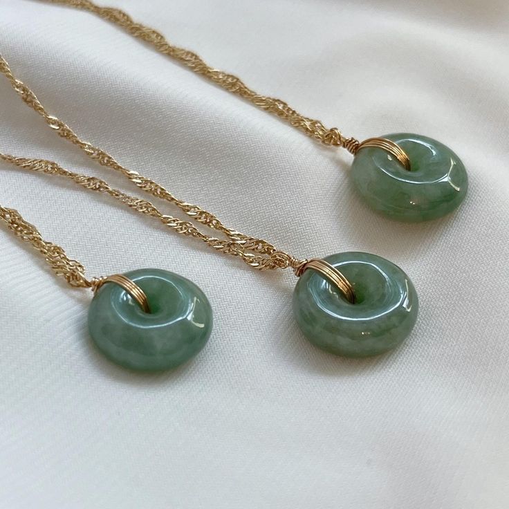 Elegant Jade Necklace - Natural Green Gemstone Pendant Elevate your style with this exquisite jade necklace featuring a natural Myanmar jade gemstone. Known for its soothing energy and timeless beauty, the jade pendant is hand-polished to perfection and carefully set in a high-quality, tarnish-resistant chain. Whether worn alone or layered with other pieces, this necklace adds a touch of elegance and serenity to any outfit. Perfect for everyday wear or special occasions, it also makes a meaningful gift for loved ones. Material: Natural Myanmar Jade, Gold filled twist chain Necklace length: 16"+2" If you have specific details like chain type or length, I can refine it further! Jade Pendant Necklace, Jade Gemstone Necklace Gift, Gold Jade Necklace With Round Pendant, Gold Jade Round Pendant Necklace, Hand-strung Round Jade Necklace, Hand-strung Round Jade Necklaces, Jade Necklace Pendant, Green Stone Necklace, Jade Necklace