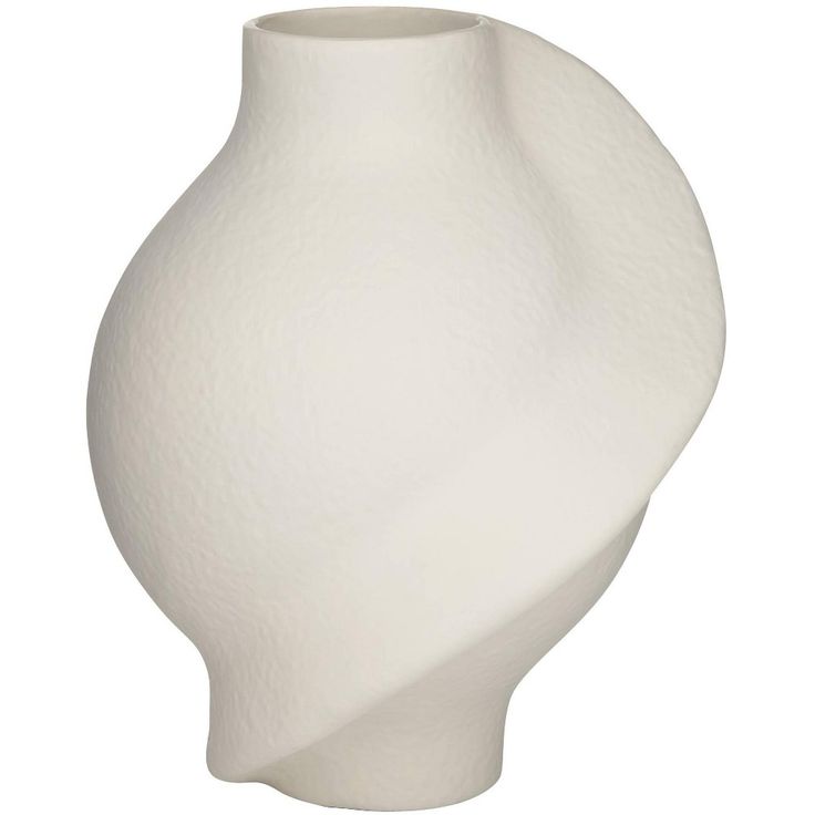 a white vase sitting on top of a table