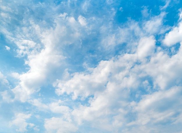 an airplane is flying in the sky with clouds