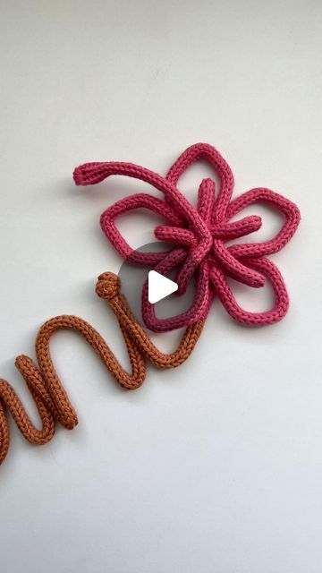 a crocheted flower with the word love spelled out