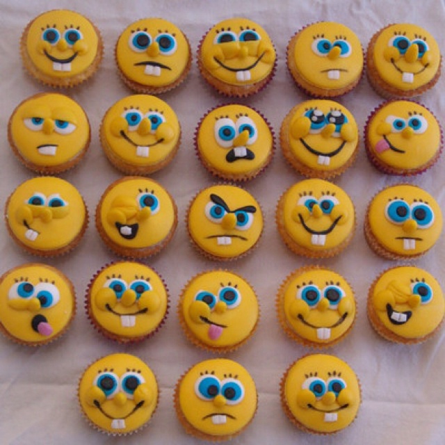 many yellow cupcakes with blue eyes and mouths