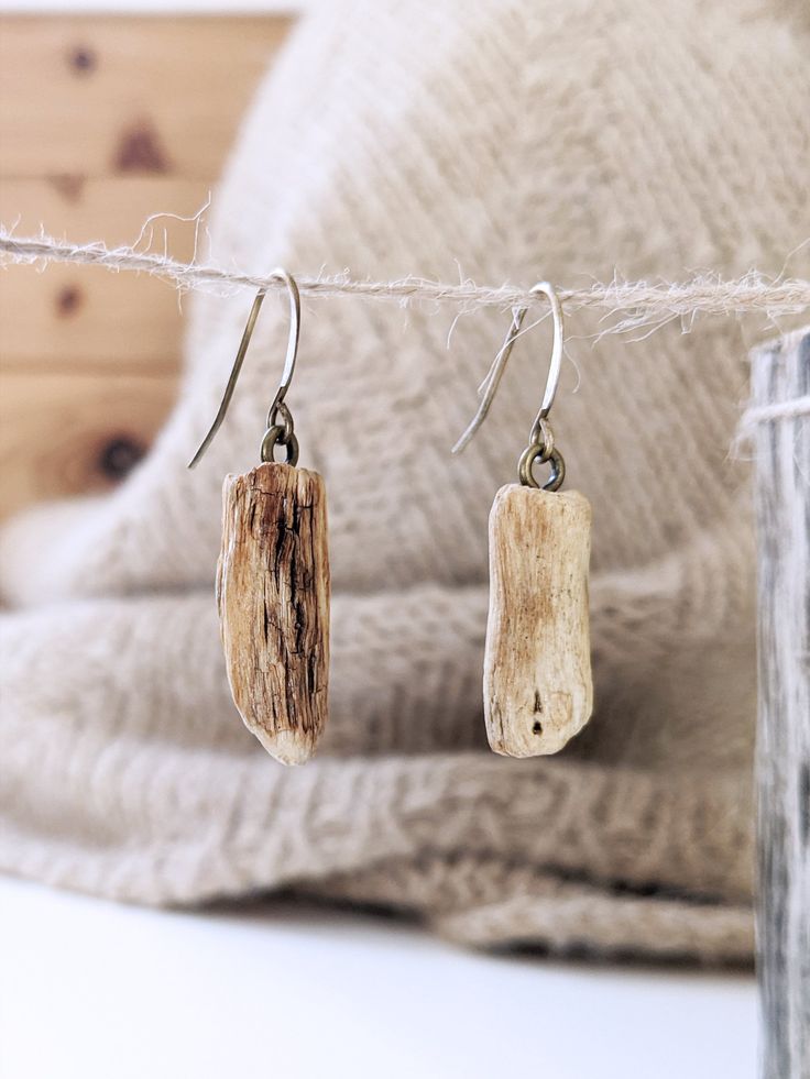 two small pieces of wood are hanging from a rope