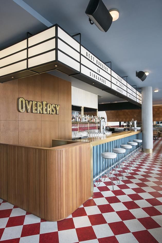 the interior of a restaurant with red and white checkered flooring on the walls