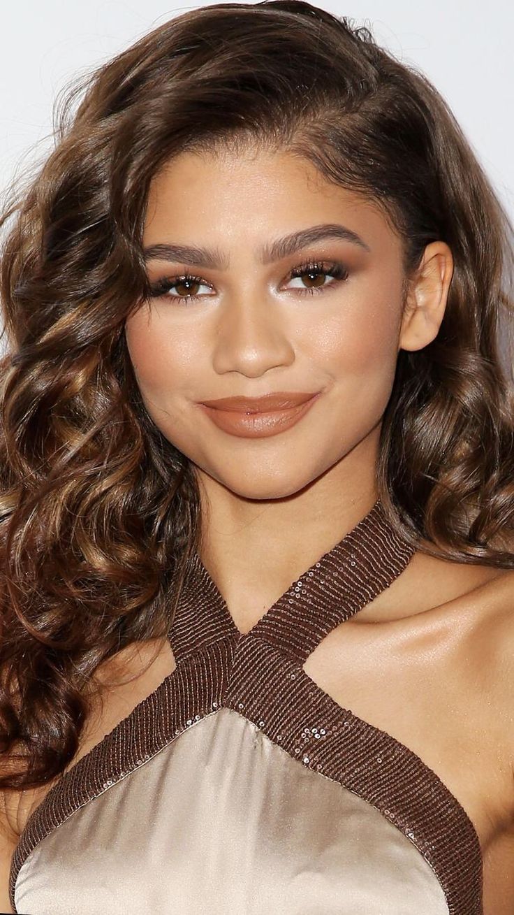 a close up of a person with long hair wearing a halter top and brown lipstick