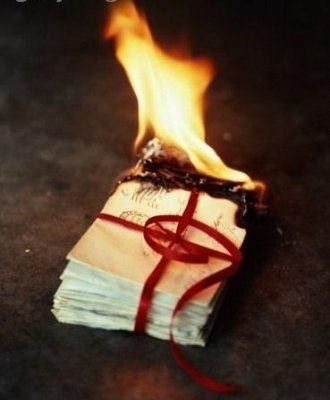 a burning book with a red ribbon on it