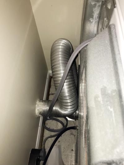 an air conditioner is connected to the side of a wall