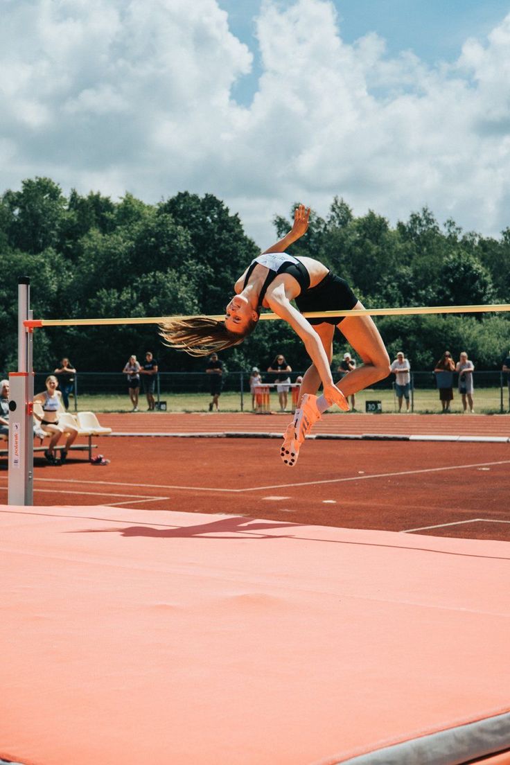 a woman jumping in the air while playing volleyball