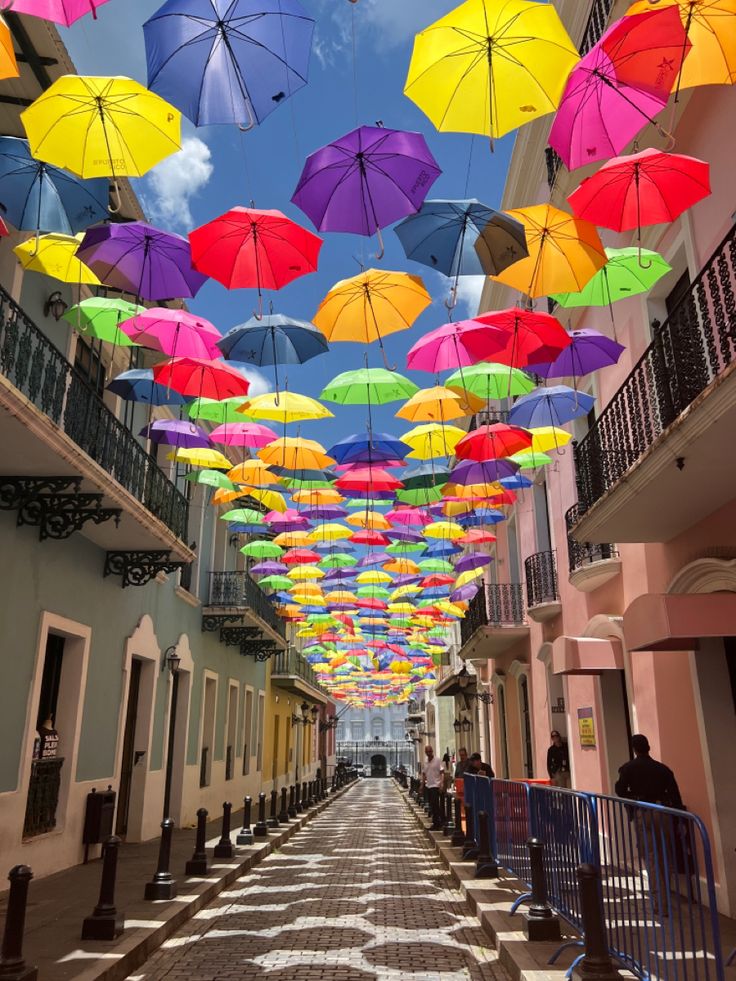 many colorful umbrellas are hanging from the ceiling