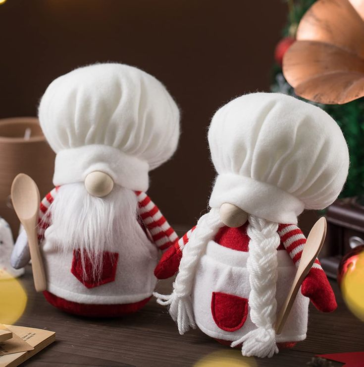 two stuffed chefs are sitting next to each other with spoons in front of them